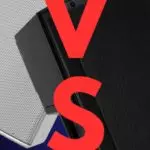 The image displays two speakers placed against a blue background, with a large red letter 'V' and 'S' on either side, suggesting a versus or comparison theme. On the left side is a white speaker, which has a clean and modern design with a visible logo on the lower part. On the right side is a black speaker with a rugged design and a logo at the bottom right corner. The overall composition suggests a comparison or competition between the two speaker models or brands.